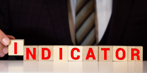 Indicator word from wooden blocks. Business and banking concept. Spot light on white background.