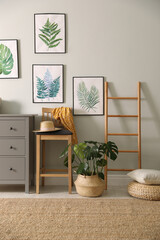 Stylish room interior with decorative ladder and monstera plant © New Africa