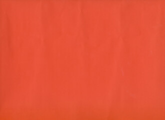 Uneven or creased orange art paper.