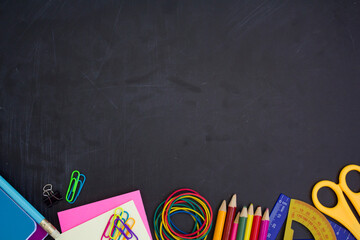 School supplies on bottom border on chalkboard Top view with copy space. Back to school concept