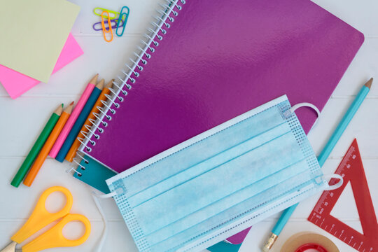 School supplies and protective face mask. Back to school during covid-19 pandemic, new normal concept
