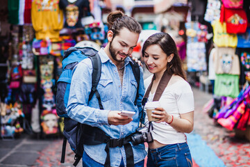 Latin couple backpacker shopping in a Tourist Market in Mexico City, Mexican Traveler in Latin America