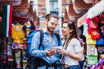 Latin couple backpacker shopping in a Tourist Market in Mexico City, Mexican Traveler in Latin America