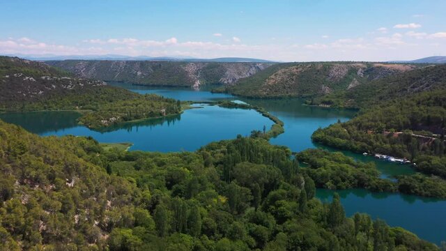 Stunning aerial view flying forward across Krka National Park lakes and waterfalls in Dalmatia, Croatia filmed in 4k.