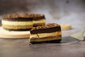 Piece of homemade triple layers chocolate bake cheesecake