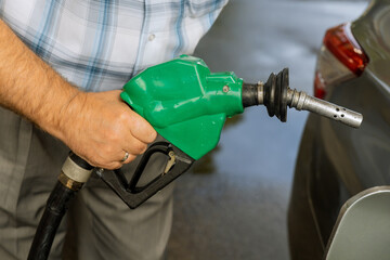 Car refueling fuel on petrol station man pumping gasoline oil. Service is filling gas