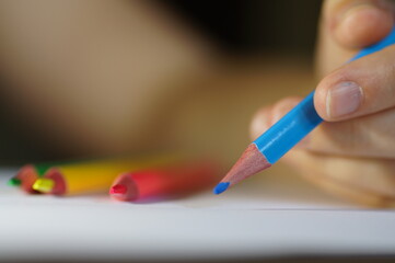 Colored pencil blue - while the student is drawing on a white sheet of paper, 

background for...