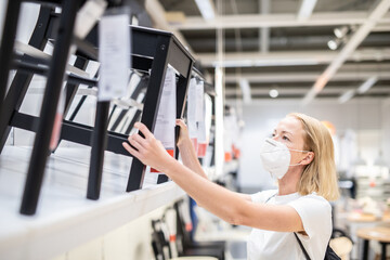 New normal during covid epidemic. Caucasian woman shopping at retail furniture and home accessories...