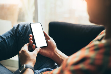 cell phone mockup blank white screen.man hand holding texting using mobile on desk at coffee shop.background empty space for advertise.work people contact marketing business,technology
