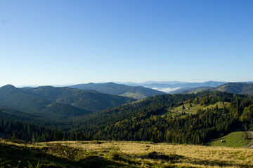 Fototapeta premium Beautiful morning landscape on the way to Transfagarasan road with forest in Romania, Carpathian mountains in autumn,aerial view from the top on valley,image for calendar,poster,cover design,postcard