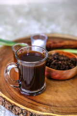 A cup of traditoional coffee from indonesia with brown sugar and milk