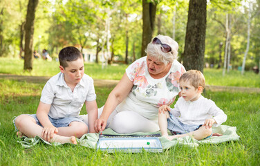 Caucasian grandmother and her grandchildren playing desktop game