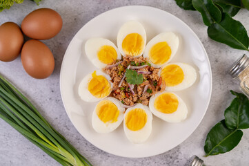 Half boiled egg and Pork Larb on a plate