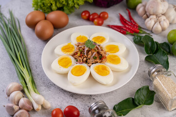 Half boiled egg and Pork Larb on a plate