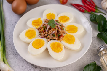 Half boiled egg and Pork Larb on a plate