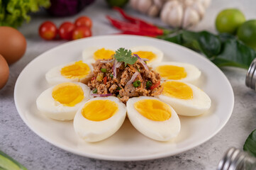 Half boiled egg and Pork Larb on a plate