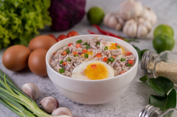 Boiled egg porridge in white bowl.