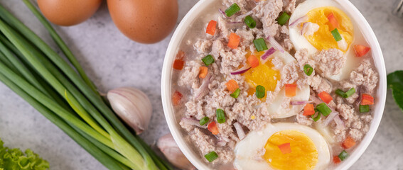 Boiled egg porridge in white bowl.