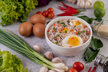 Boiled egg porridge in white bowl.