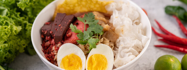 Yentafo with boiled egg, spring onion, chili, lime and garlic.