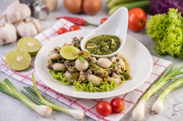 Spicy Squid Salad with White Platter with Spring Onion, Chili, Lime and Tomato.