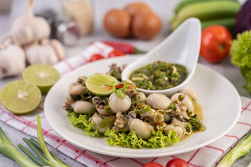 Spicy Squid Salad with White Platter with Spring Onion, Chili, Lime and Tomato.