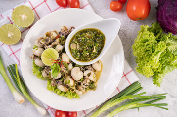 Spicy Squid Salad with White Platter with Spring Onion, Chili, Lime and Tomato.