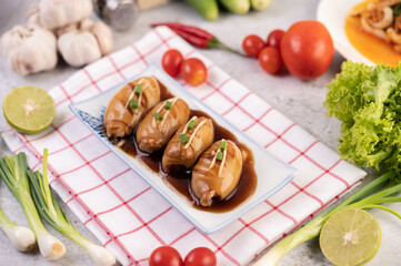 Squid stuffed with pork topped with black sauce.