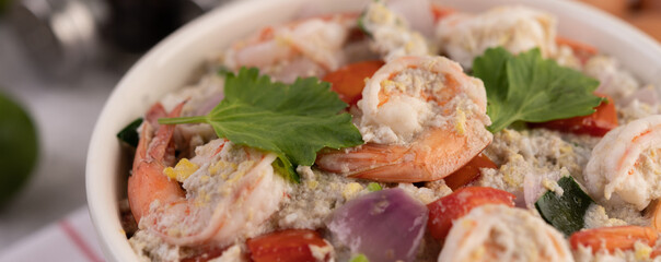 Shrimp Salad with Tomato Red onion and coriander in a white cup.