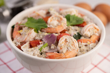 Shrimp Salad with Tomato Red onion and coriander in a white cup.