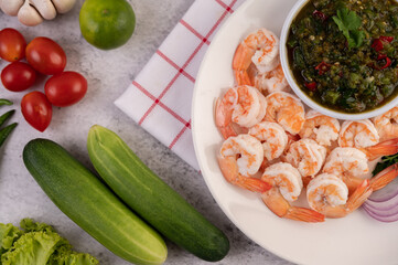 The cooked prawns are arranged in a plate with dipping sauce.