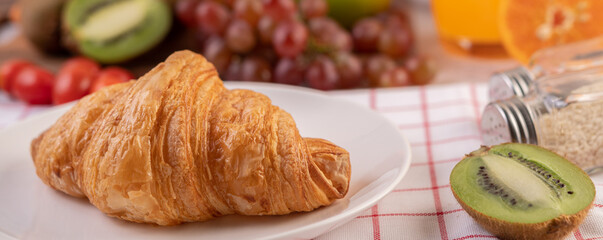 Croissant in a white plate.