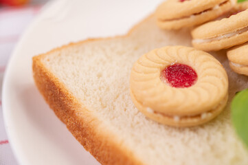 Bread and buns stuffed in a white plate.