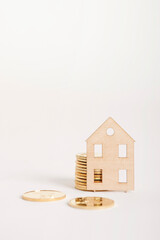 cut-out paper house and coin