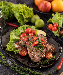Sliced ​​pork steak topped with white sesame and fresh pepper seeds along.