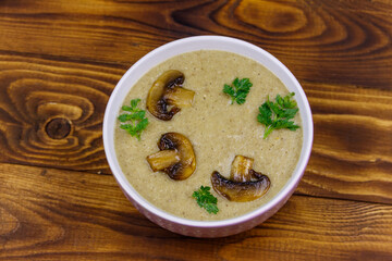 Mushroom cream soup on a wooden table. Top view