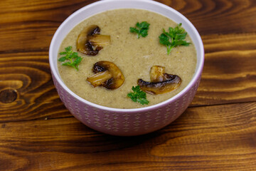 Mushroom cream soup on a wooden table