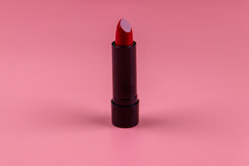 Red lipstick on a pastel pink background