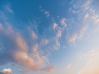 Whimsical clouds in the blue sky. Summer evening