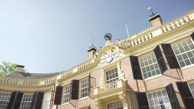 Tilt reveal shot of front exterior of Groeneveld Castle, Utrecht