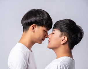 Two men in love wearing white t-shirts looked at each other's faces.