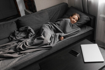 beautiful caucasian woman sleeping on the sofa at home and having good dreams smiling. Healthy, full sleep.