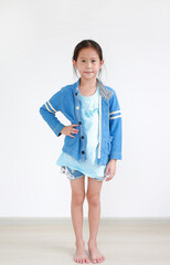 Fototapeta premium Portrait asian little child girl with arm akimbo in the room. Full-length