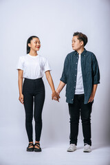 Two loving women standing and holding hands.