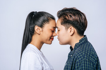 Women couples stand and fragrant cheek.