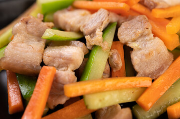 Stir-fried carrots and cucumber with pork belly.
