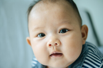 A newborn baby who opens his eyes and looks forward