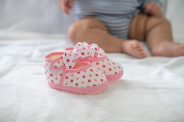 Newborn shoes placed on a white mattress