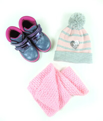 Autumn or winter outfit. Girl's fashion clothes on the white wooden background.