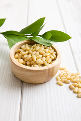 pine nuts in wooden bowl